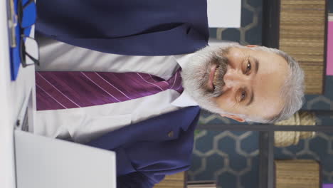 Vertical-video-of-Cheerful-old-businessman-dancing-looking-at-camera.